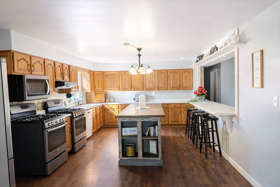 Spacious country kitchen in Peaceful Country Escape with two stoves, perfect for cooking meals for families and groups.