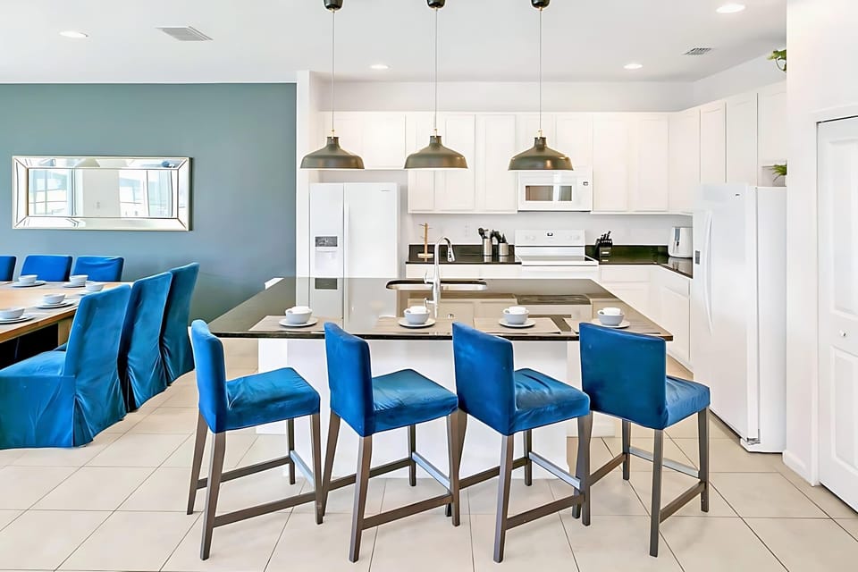 Spacious Kitchen With Sleek Countertops And Island Seating For Four
(property differs from the photo)