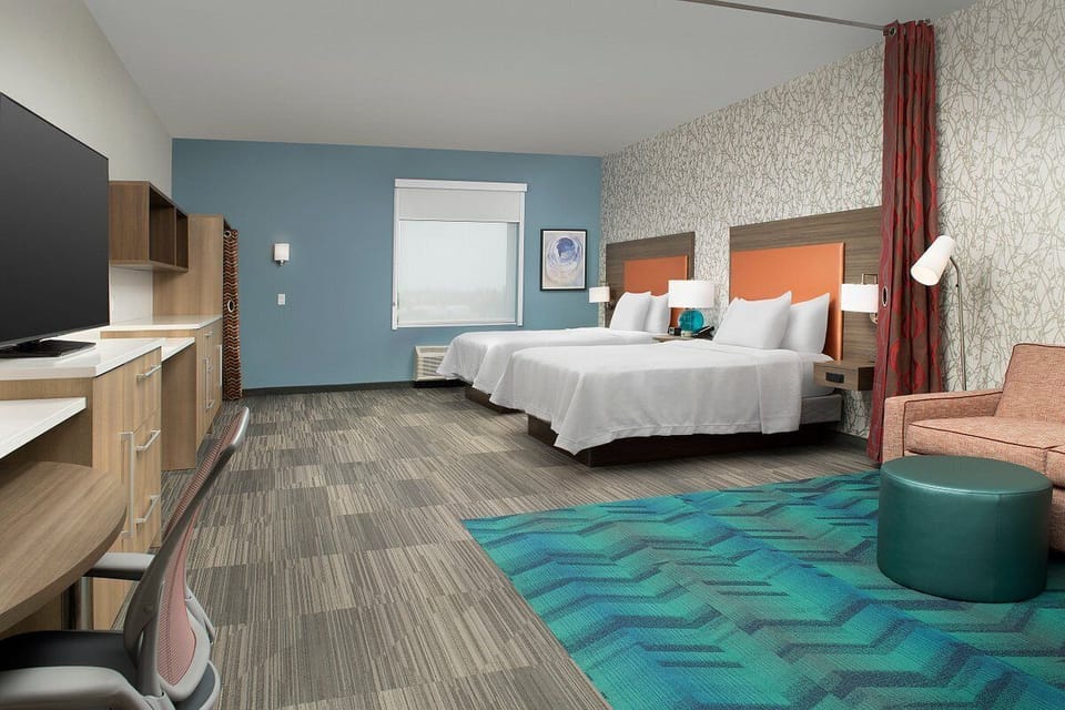 Relax together in a spacious double-bed room with lounge area.