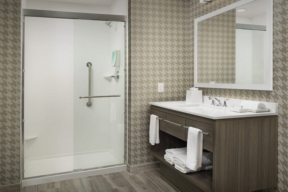 Refresh in a spotless bathroom with roomy walk-in shower.