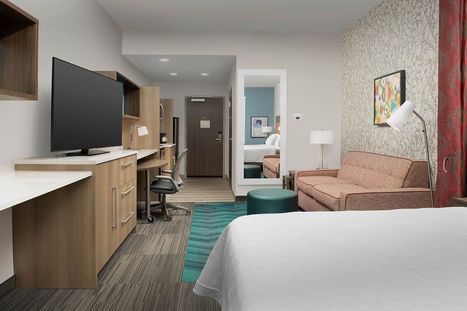 Settle in with a spacious layout, TV, and work desk.