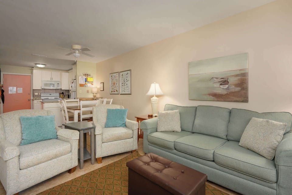 Bright, open living room with smart TV, sleeper sofa, and private patio access