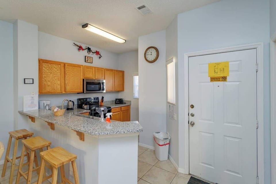 Main Floor | Full Kitchen | Breakfast Bar Seating
A bright, well-appointed kitchen welcomes you with granite countertops, modern appliances, and casual bar seating perfect for morning coffee or evening snacks.