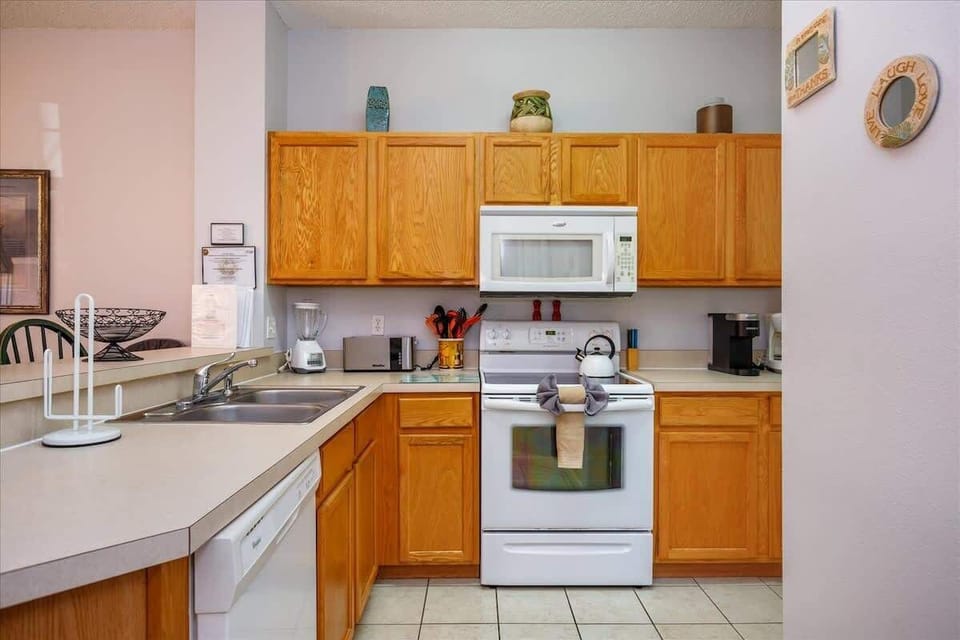 Ground Level | Full Kitchen | Bright + Well-Appointed
With cheerful cabinets and spacious counters, this kitchen is thoughtfully stocked and ready for anything from breakfast to dinner prep.