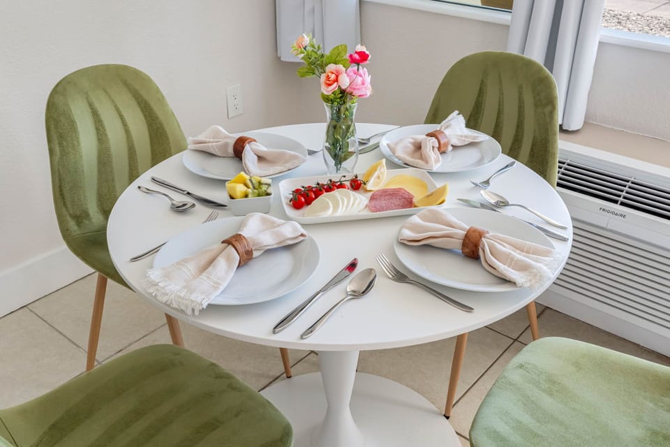 Elegant green velvet chairs add a soft, stylish touch.