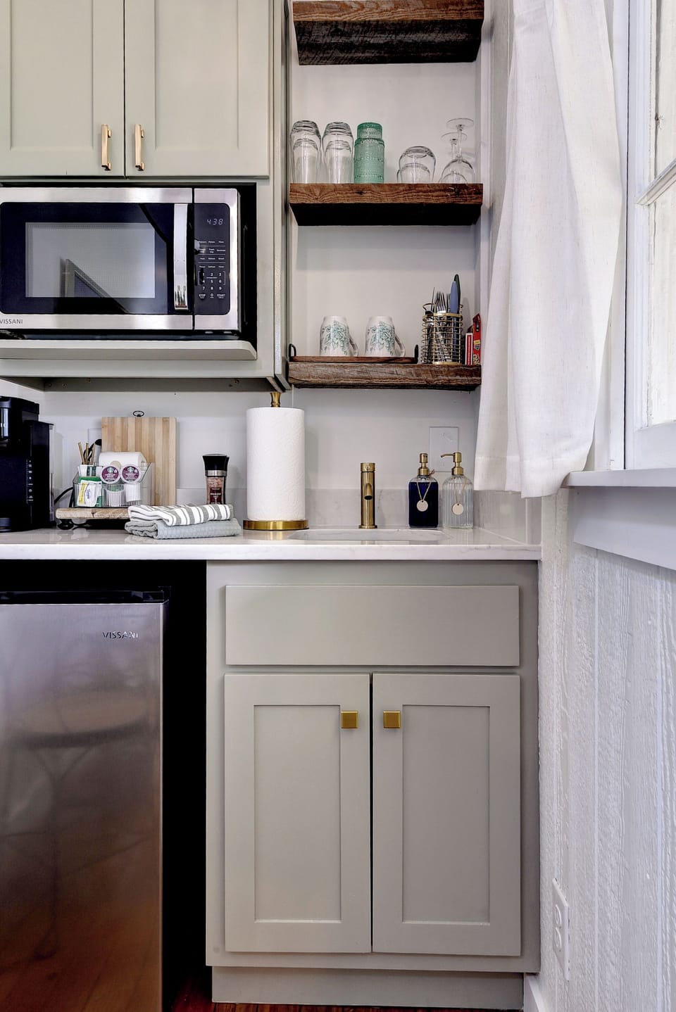 Bright kitchenette with coffee bar, mini-fridge & open shelves