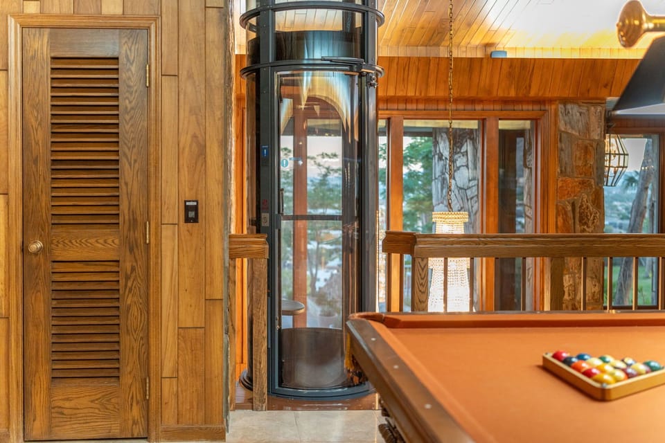 Single person glass elevator to billiards loft