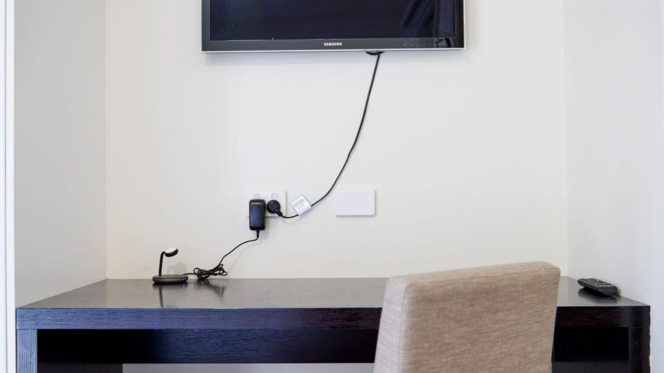 Workspace with mounted TV and charging outlets