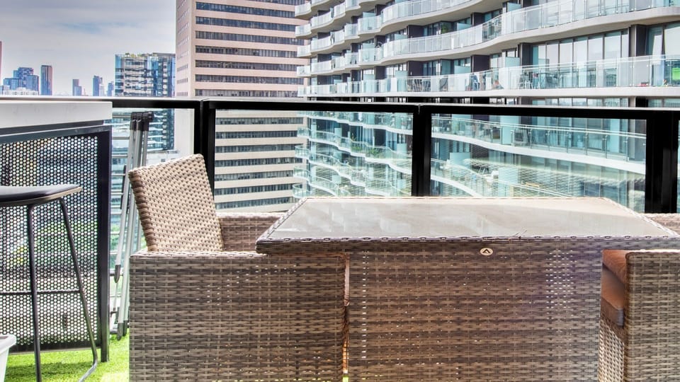 Private balcony with outdoor seating and urban views.