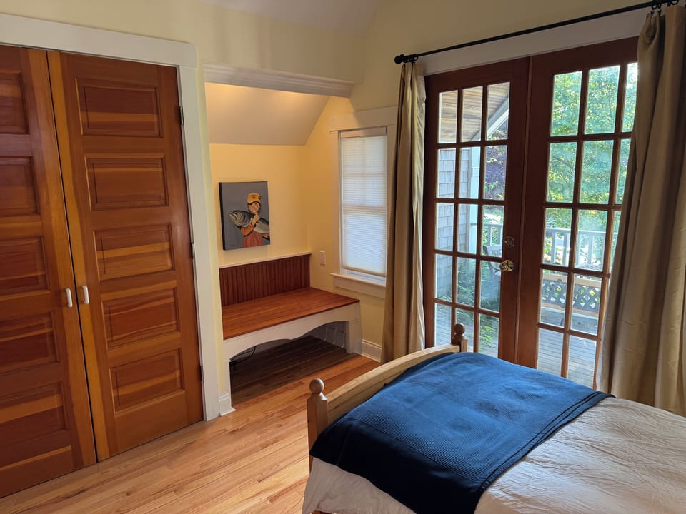 View of the closet, balcony and seating area in the secondary bedroom.
