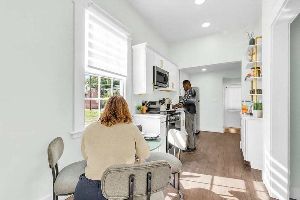 DINE & CELEBRATE! Main floor kitchen: Elegant dining room for family meals. Turn dinner time into vacation traditions! Modern table, comfortable seating. Book now! #FamilyDining #SavannahCharm