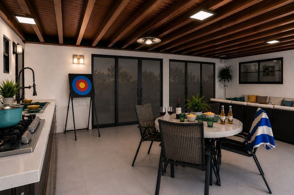 OUTDOOR COOKING & DINING MAGIC! Covered patio with gas cooktop, sink. BBQ, fire table, sofa lounging, heated pool.  Perfect for families who love outdoor living.
#OutdoorKitchen  #CoveredPatio #CookingOutside #Hollywoodairbnb #Bestairbnbmiami