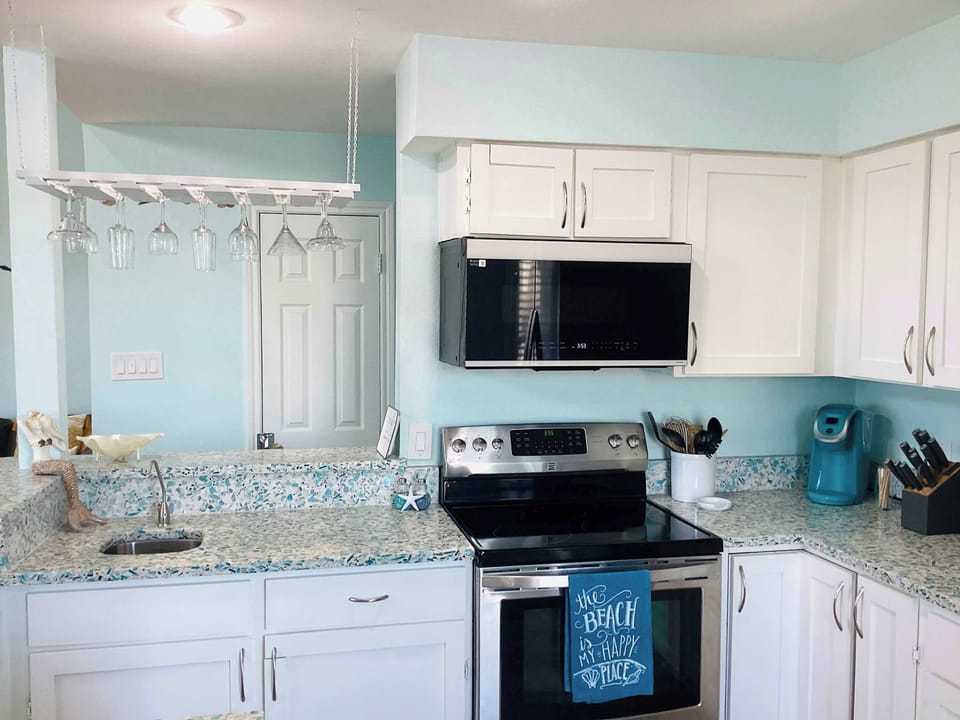 Fully equipped kitchen with a separate bar and open concept.
