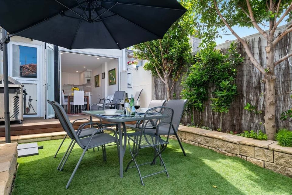 COURTYARD: Enjoy al fresco dining and entertaining in the sunny rear courtyard with cantilevered umbrella if it get to hot. A barbeque is provided.
