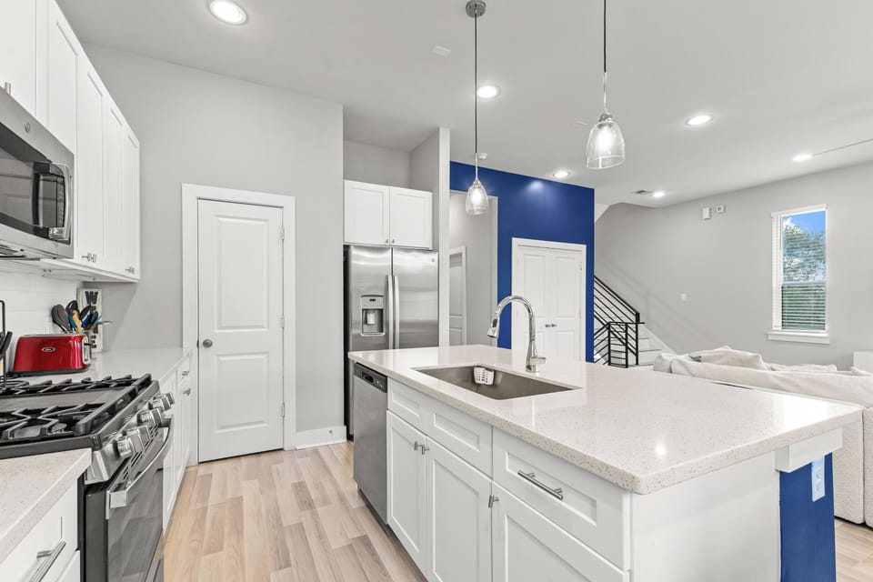 Fully equipped kitchen with stainless steel appliances and ample counter space.