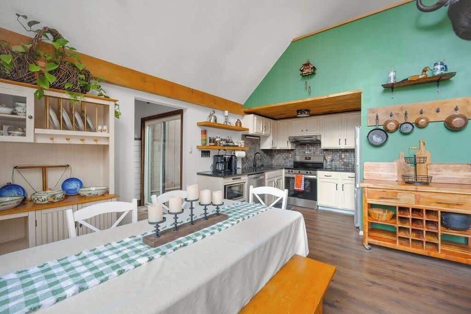 A cozy, open dining and kitchen space filled with natural light and rustic touches.