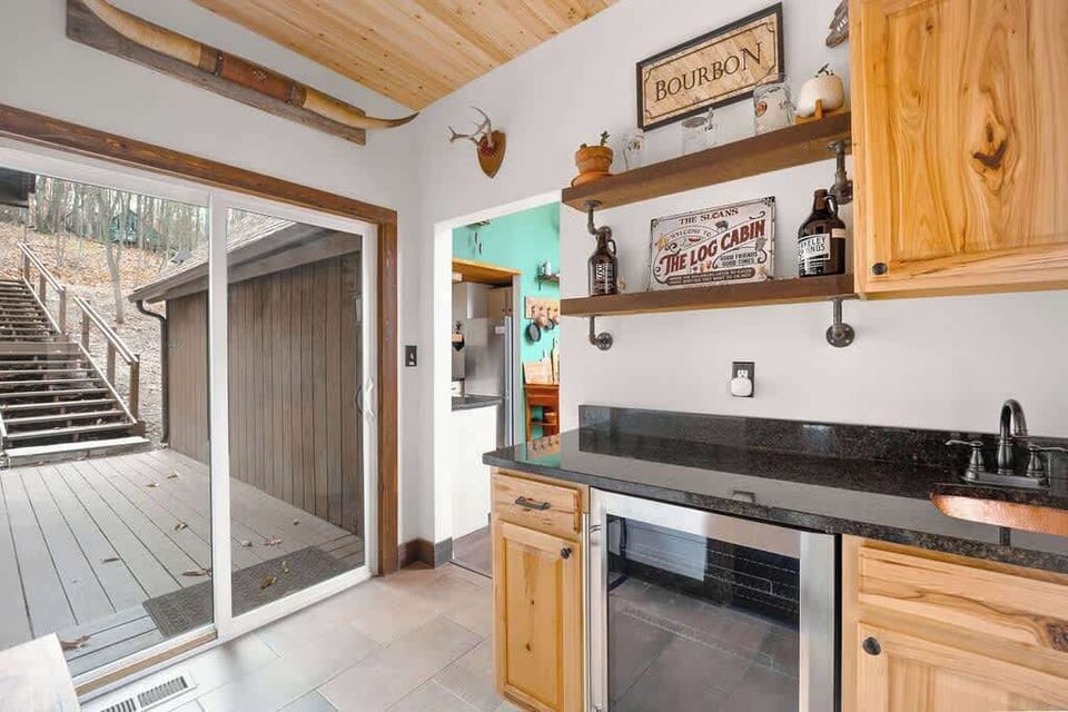 Charming bar space with rustic details, modern appliances, and direct access to the outdoor walkway.