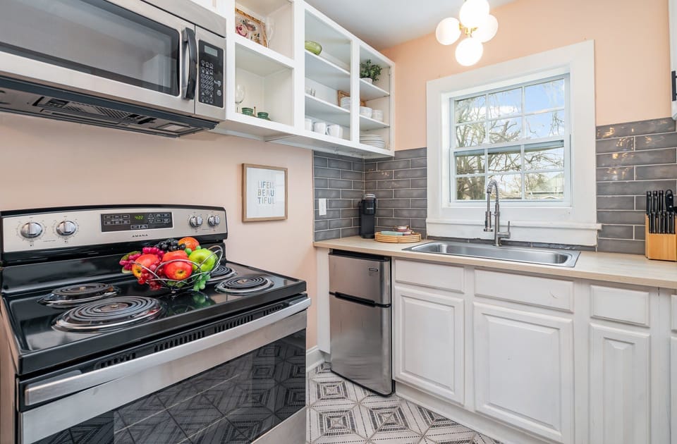 Essentially equipped kitchenette featuring stainless-steel appliances and a dining area for 2 guests.