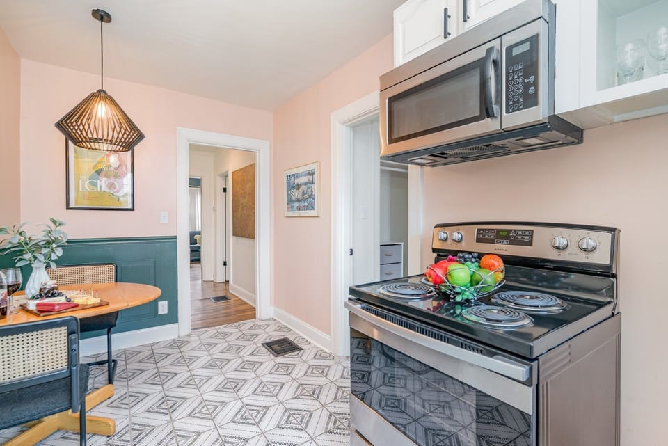 Essentially equipped kitchenette featuring stainless-steel appliances and a dining area for 2 guests.