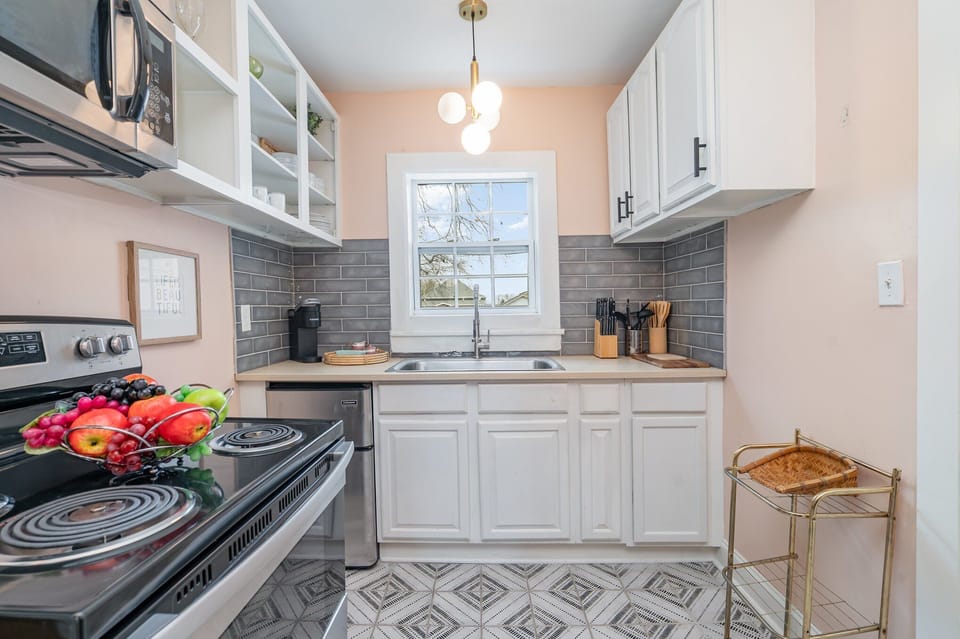 Essentially equipped kitchenette featuring stainless-steel appliances and a dining area for 2 guests.