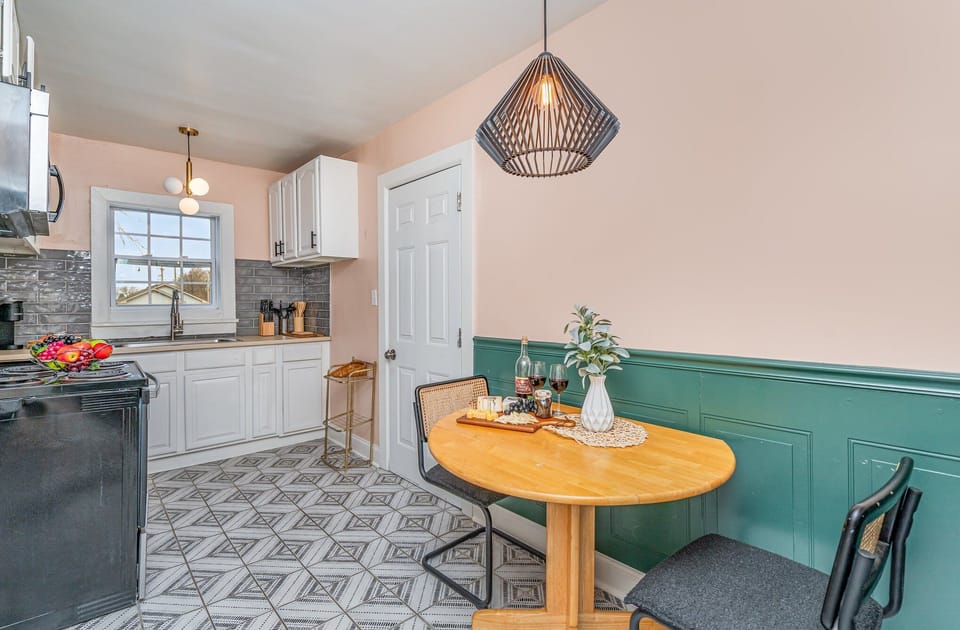 Essentially equipped kitchenette featuring stainless-steel appliances and a dining area for 2 guests.