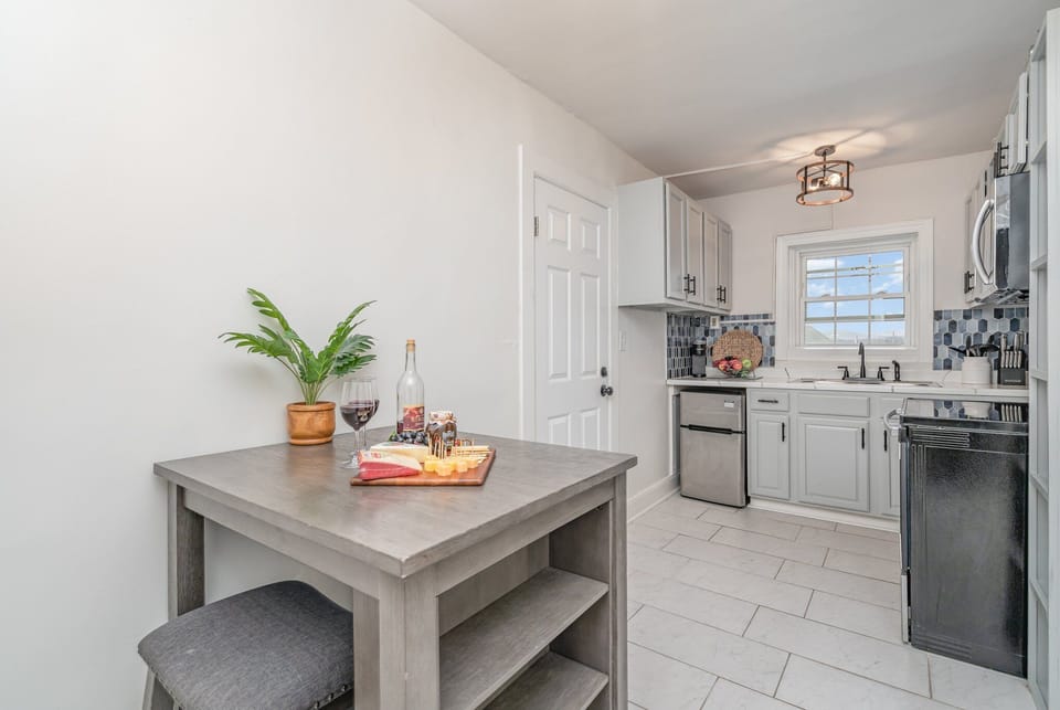 Fully equipped kitchen, complete with stainless-steel appliances and a dining area for 2 guests.