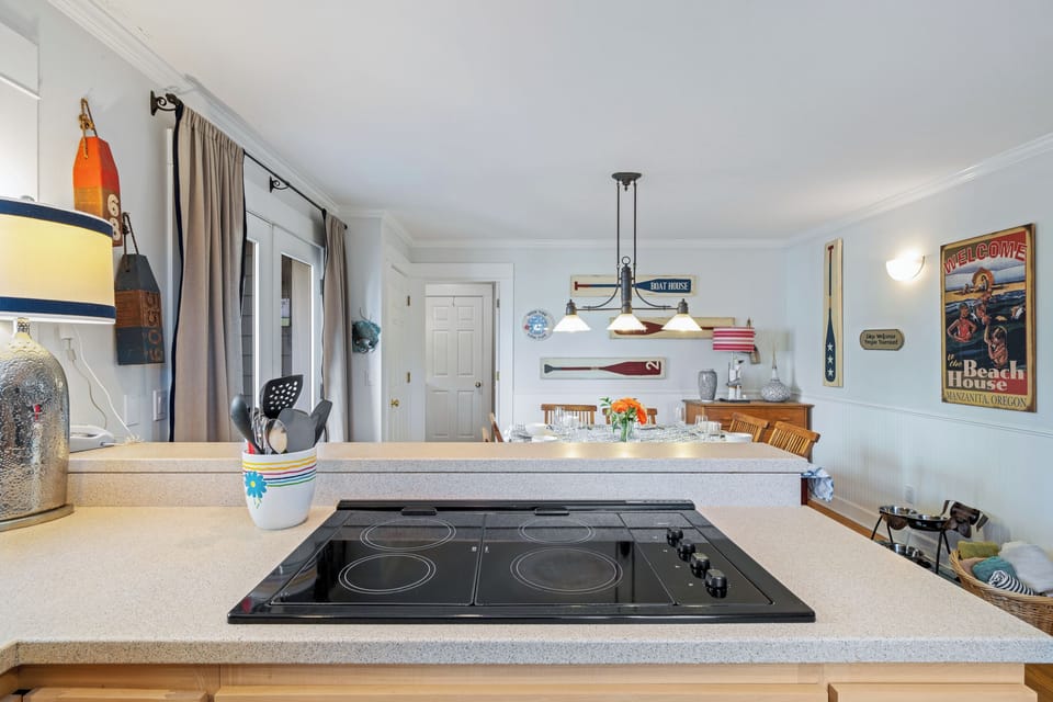 Jenn-Air stove, double oven, dishwasher, fridge, and open to the dining room