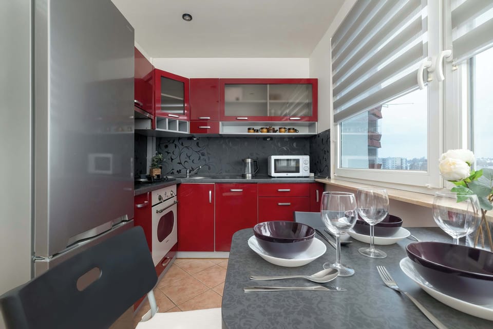 Dining area next to a fully equipped modern kitchen.