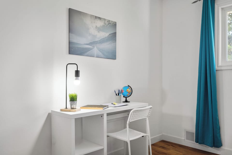Quiet workspace with desk and lamp perfect for remote work.