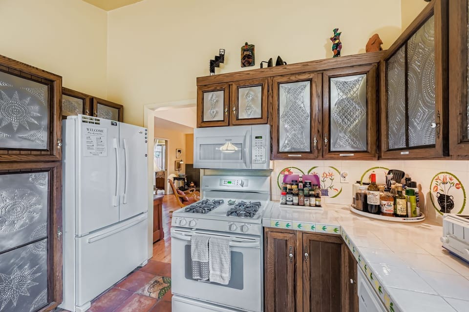 Step into your fully equipped kitchen where you'll find everything you need to create delicious meals during your stay. Rich wood cabinets with decorative glass panels and modern appliances make cooking a pleasure.