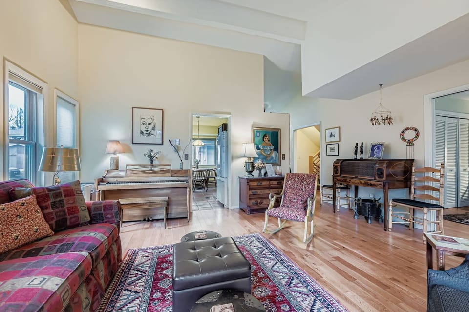 Step into your charming retreat where warm hardwood floors and eclectic vintage furnishings create a cozy, artistic atmosphere that feels like home away from home.