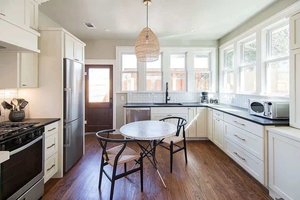 Charming Kitchen: Bright and airy space with modern appliances and sunlit dining for culinary adventures!