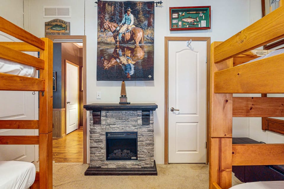 Fun sleeps await with rustic decor and a charming faux stone fireplace!