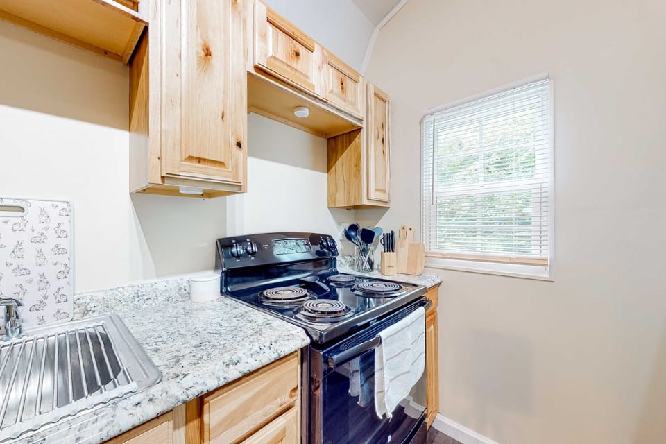 Whip up culinary delights in this well-equipped kitchen with ample natural light!