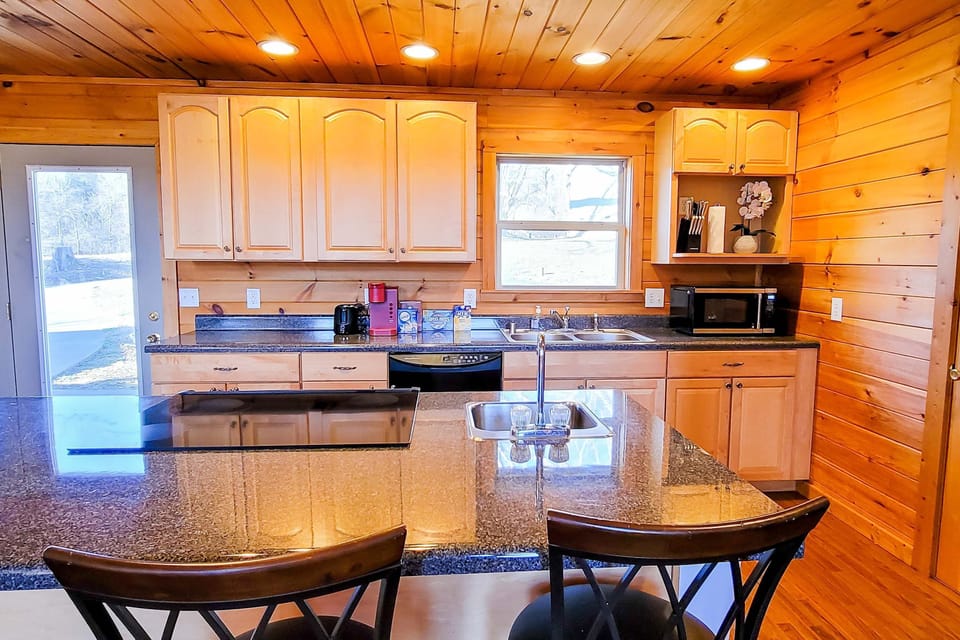 Kitchen delight awaits. A spacious granite countertops and sunlight streaming in, perfect for culinary adventures!
