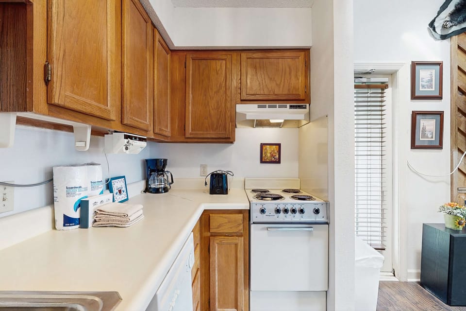 Kitchen delight awaits. And, whip up meals in this bright, well-equipped kitchen with charming decor!