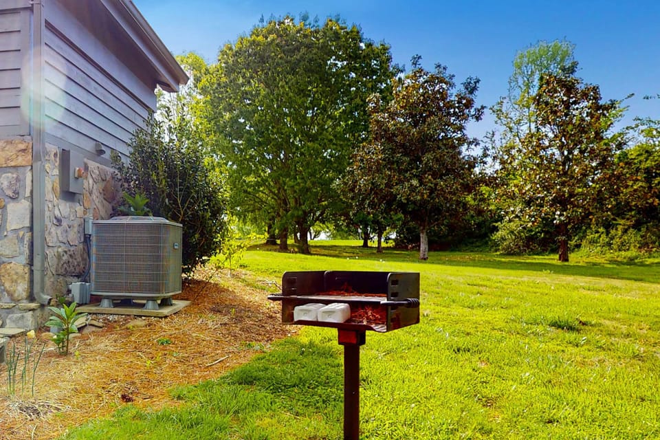 Outdoor Grill Station awaits. Perfect for sizzling cookouts amid lush greenery and sunny skies!