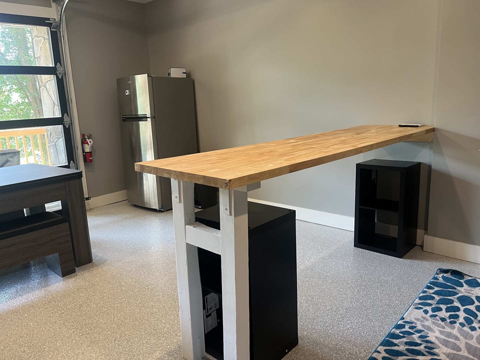 Fun bonus room with bar-height table, mini fridge, and extra hangout space. Great for game nights, group trips, family vacations, and relaxing cabin entertainment.