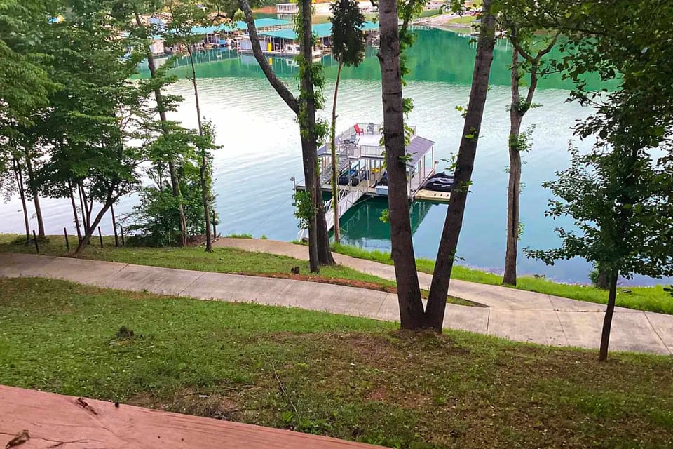 Breathtaking view overlooking the lake and private dock. Enjoy easy waterfront access for boating, fishing, swimming, and unforgettable lakefront vacations.