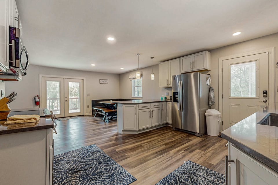 Bright open-concept kitchen with stainless appliances and plenty of space. Perfect for cooking family meals, group stays, and relaxing cabin vacations with modern comforts.