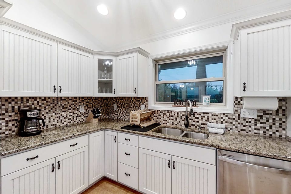 Whip up delicious meals in a stylish space with modern appliances and scenic views!