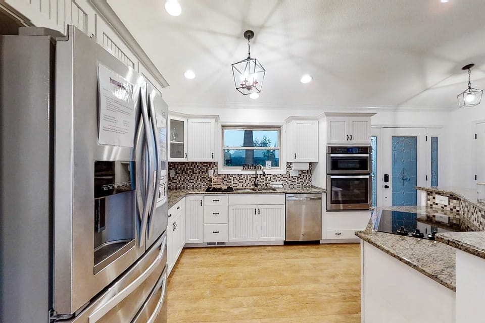 Explore culinary delights in a spacious, light-filled kitchen with modern amenities!