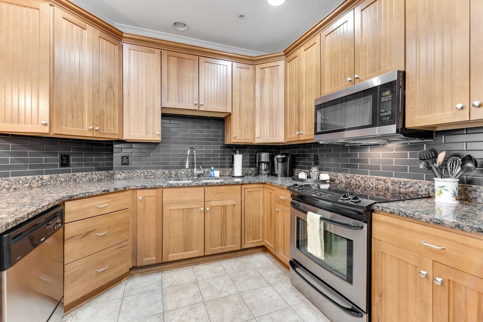 Whip up culinary delights in this stunning, modern kitchen with sleek granite finishes!