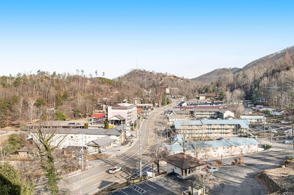 Panoramic views of downtown Gatlinburg with rolling Smoky Mountains in the background. Stay close to restaurants, attractions, and outdoor adventures in this prime location.