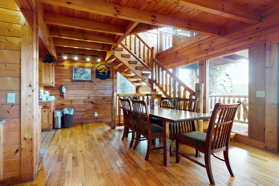 Gather around the rustic wooden table in a sunlit haven with mountain views!