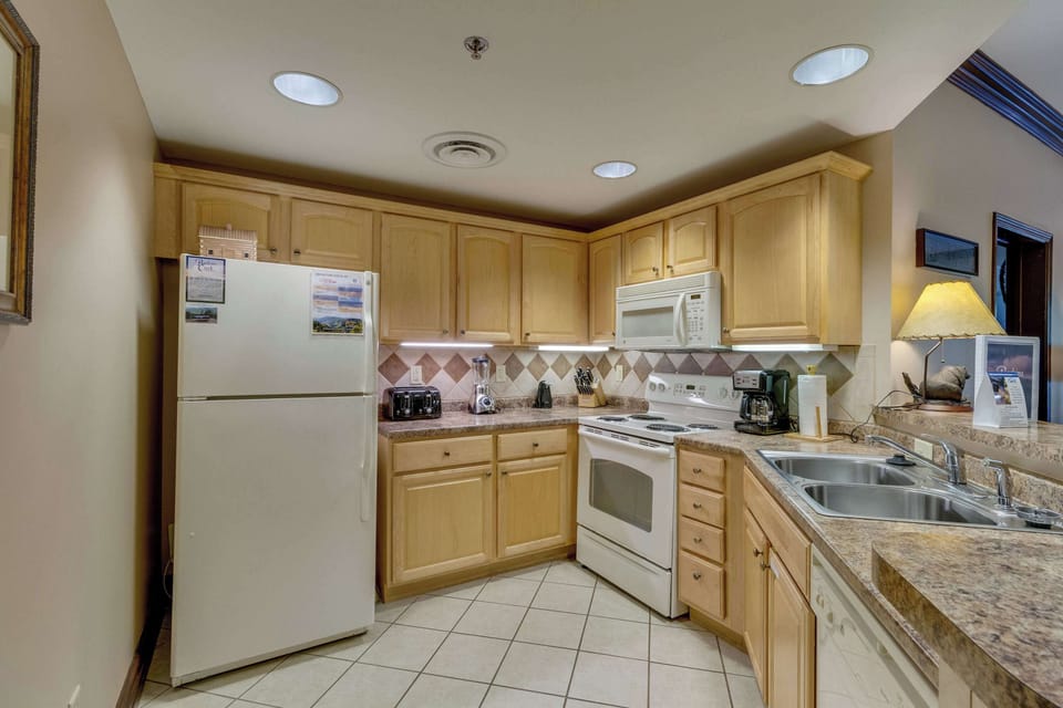 Whip up delicious meals in a bright space with modern appliances and warm wood accents!