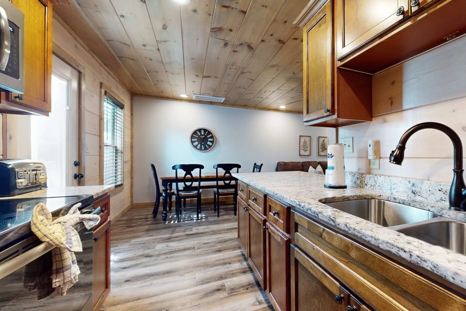 Modern appliances meet rustic charm in this inviting space for culinary adventures!