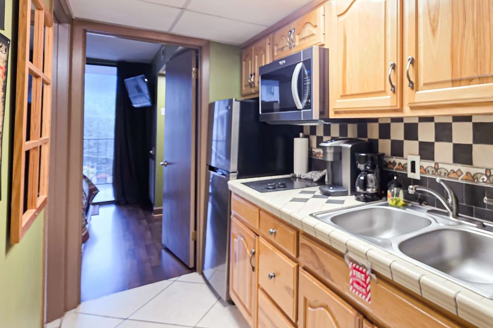 Whip up meals in this stylish space with sleek appliances and mountain views!