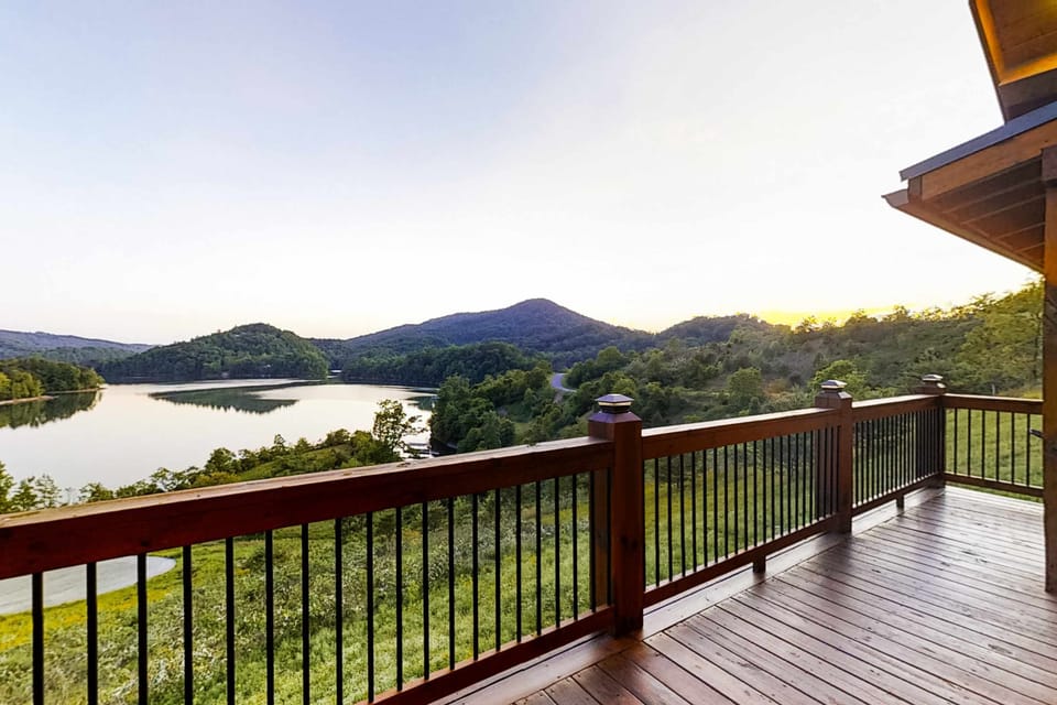 Private deck overlooking the lake and rolling Smoky Mountains. Enjoy sunrise coffee and sunset views at this lakefront cabin retreat.