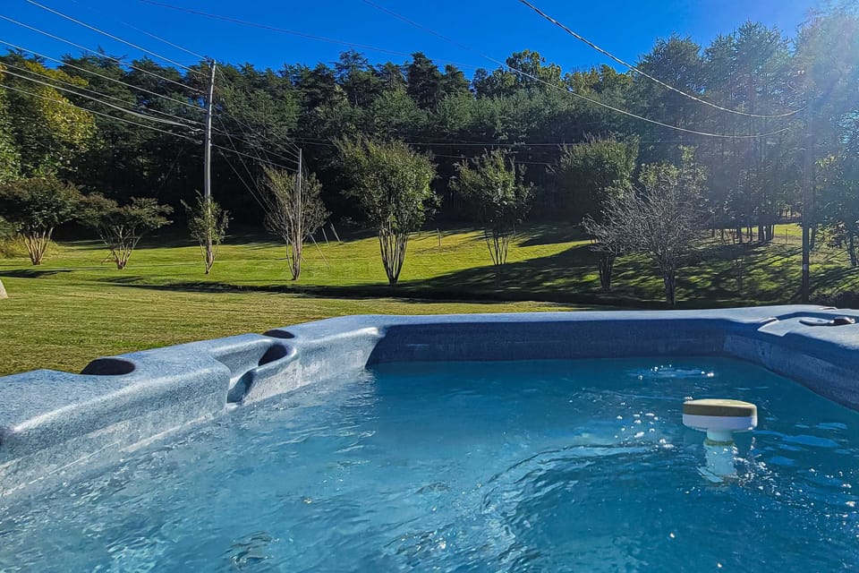 Hot tub haven awaits. And, relax and soak in breathtaking views of lush greenery and clear blue skies!